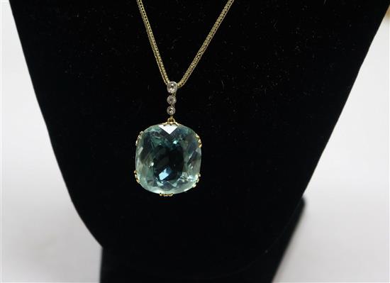 A yellow metal fancy cut aquamarine and diamond set drop pendant, on a yellow metal chain, aquamarine approx. 22mm.